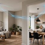 modern home interior with two smoke detectors visible in different rooms connected by a subtle glowing line effect suggesting